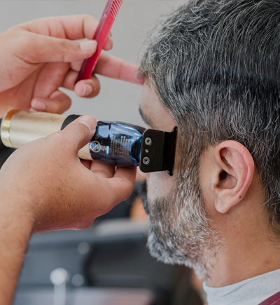 Barber giving a haircut at Daly Grove, Edmonton